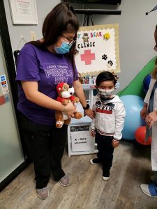 Nurse Giving Gift To Boy in Houston, TX