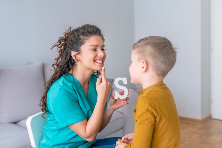 Speech-language pathologist aiding a child in Houston, TX
