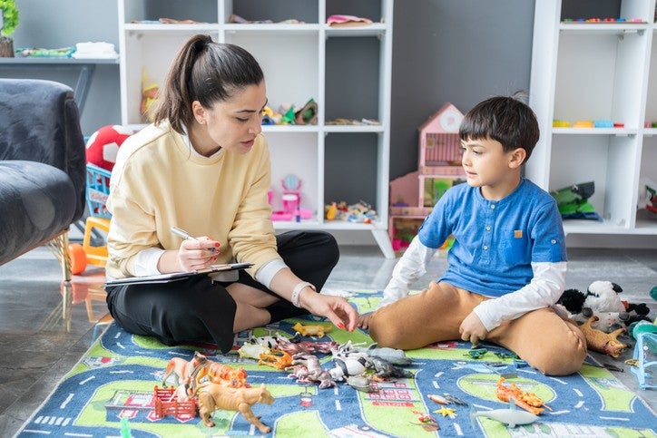 Healthcare professional offering comprehensive home health care services to a young child in Houston, TX