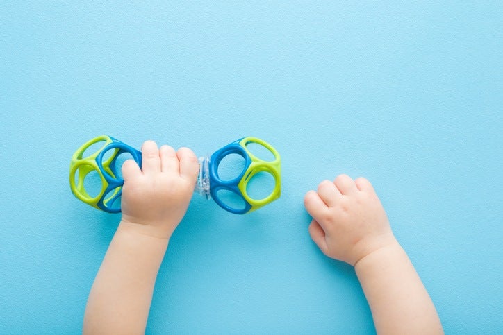 Babies learning pincer grasp with colorful toys in Houston, TX